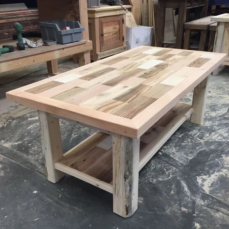 Coffee table with a patchwork top of mixed timber blocks, rustic legs and a slatted shelf