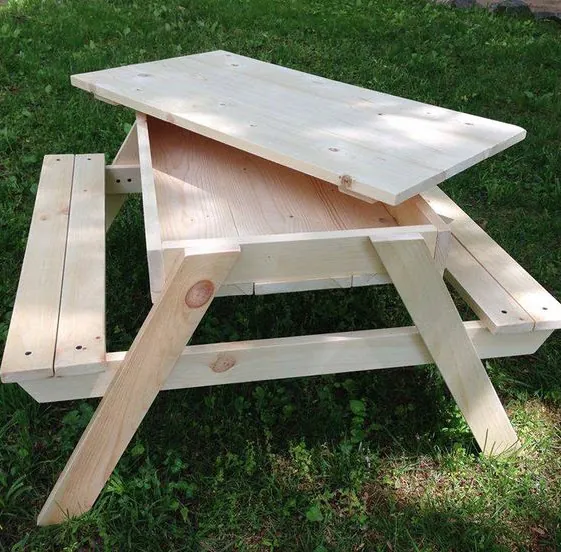 Pine kids' picnic table with a lift-off top hiding a sandpit, with two bench seats