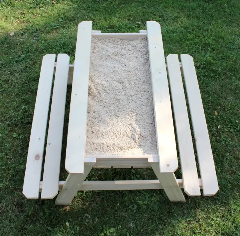 Pine kids' picnic table seen from above with the top removed to show a sand-filled centre