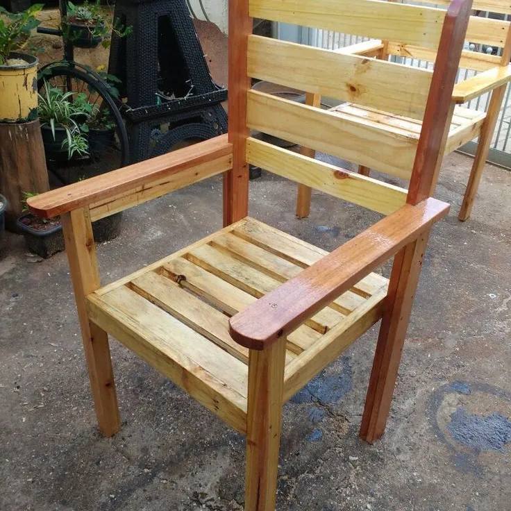 Pine armchair with a slatted seat, ladder back and glossy varnished armrests