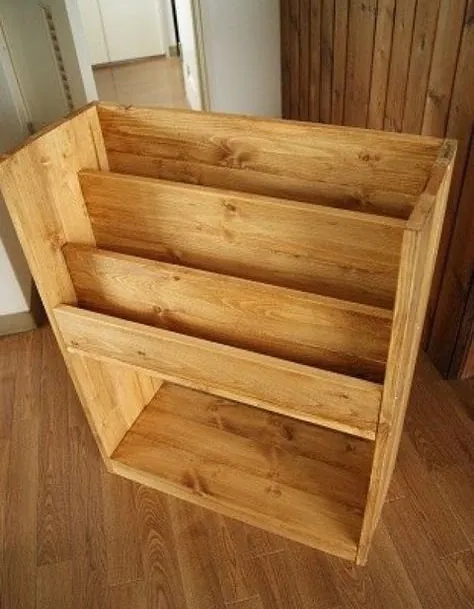 Stained pine kids' book rack with three angled tiers and an open lower shelf