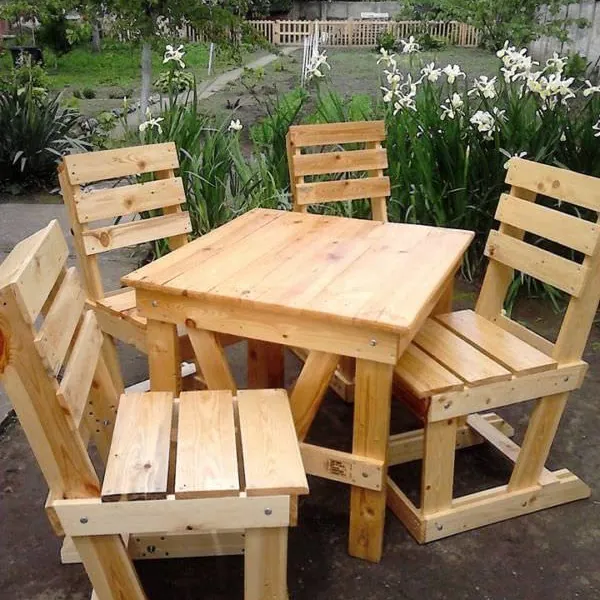Raw pine patio set with a square table and four slatted-back chairs in a garden