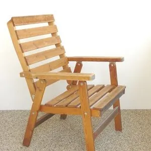 Honey-stained slatted garden armchair with a reclined back and flat armrests