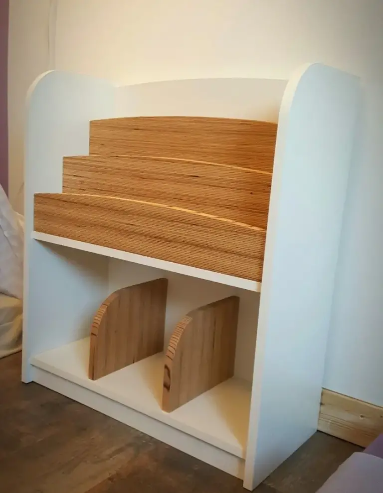 White kids' bookshelf with stepped birch plywood book tiers and plywood bookends below