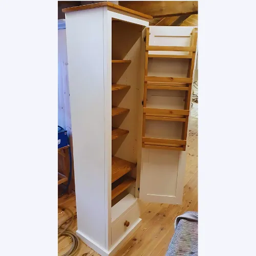 White pantry cupboard with pine shelves and door-mounted spice racks